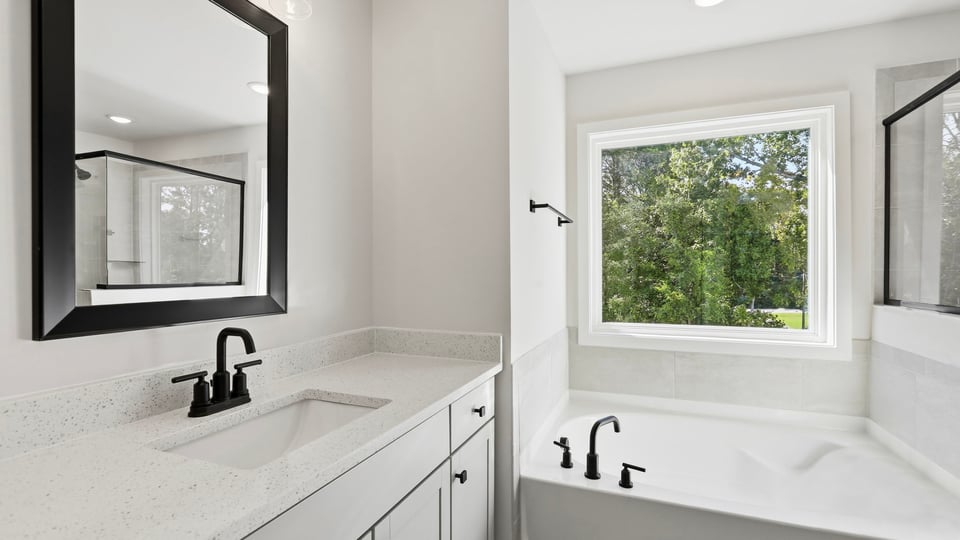 Bathroom with window and batttub.