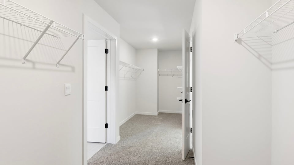 Closet with hanging storage racks.