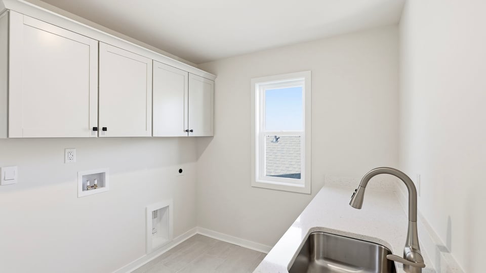 Laundry room with hanging storage racks.