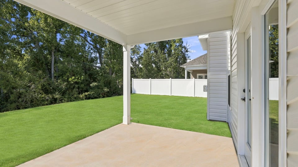 Back exterior of home with covered patio.