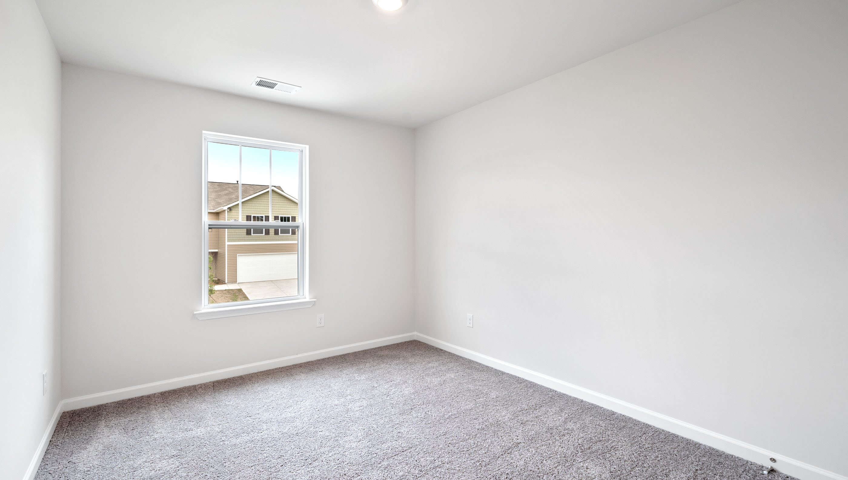 Bedroom with carpet and windows.