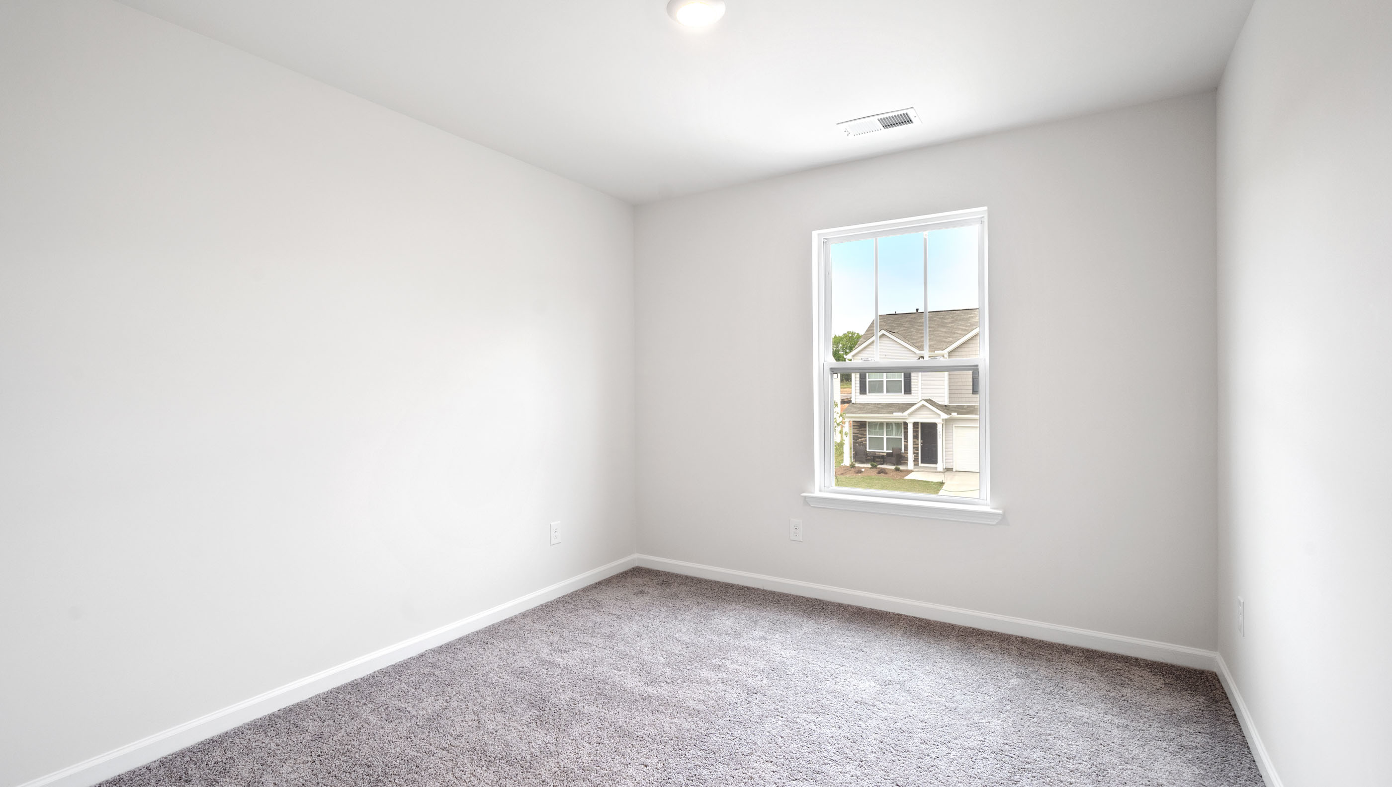 Bedroom with carpet and windows.