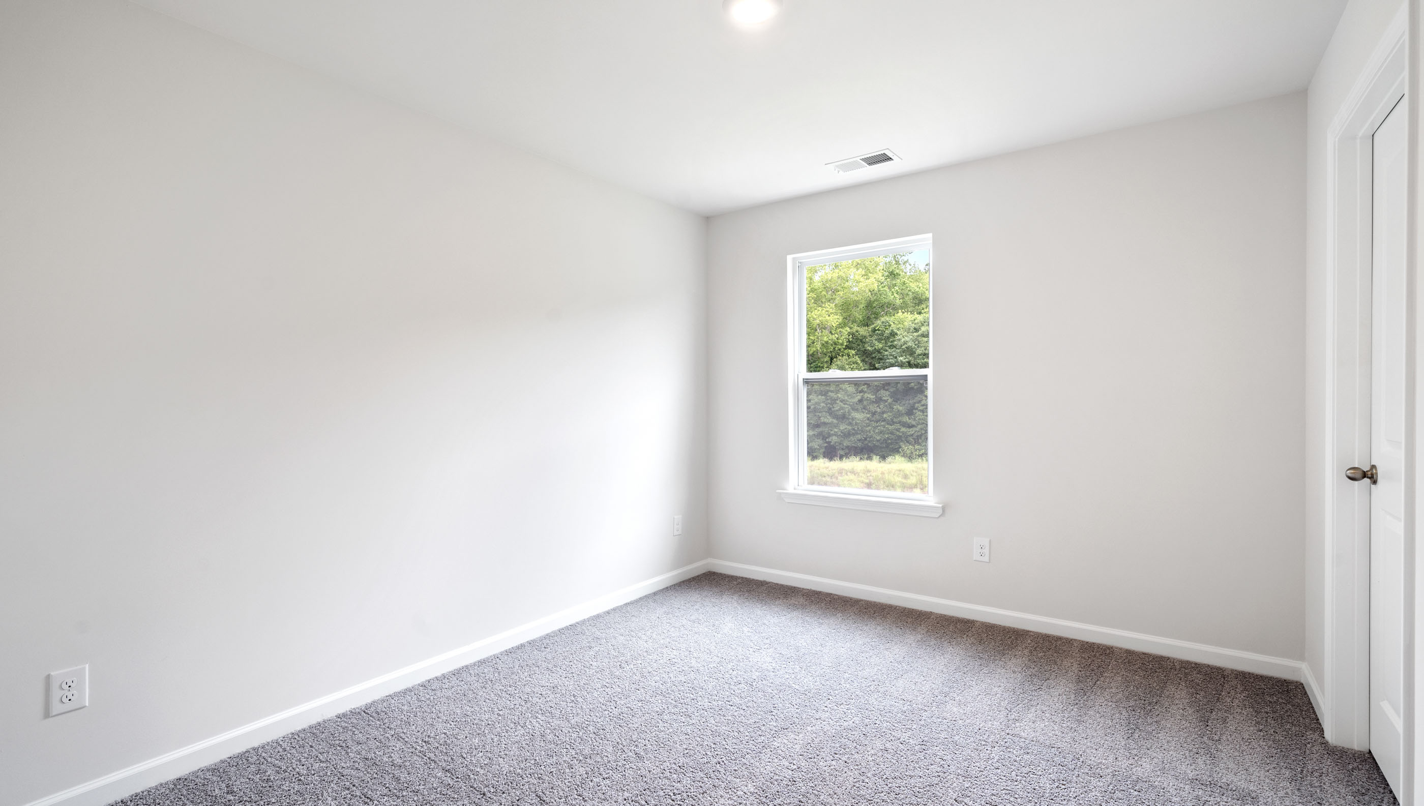 Bedroom with carpet and windows.