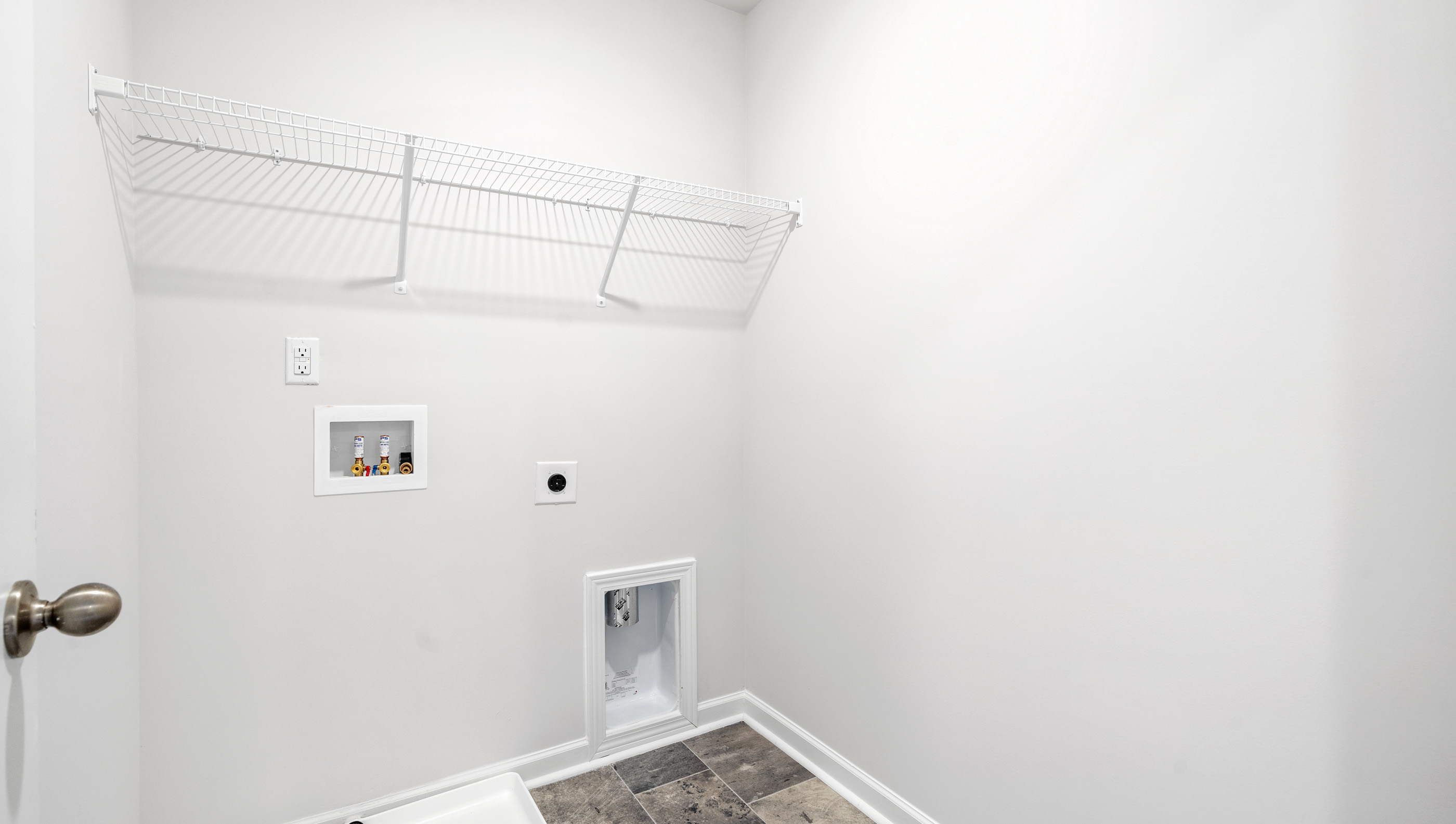 Laundry room with shelf.