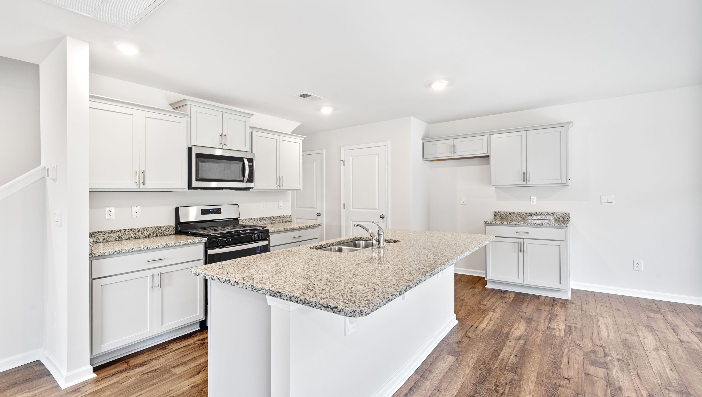 Kitchen with island and cabinets.