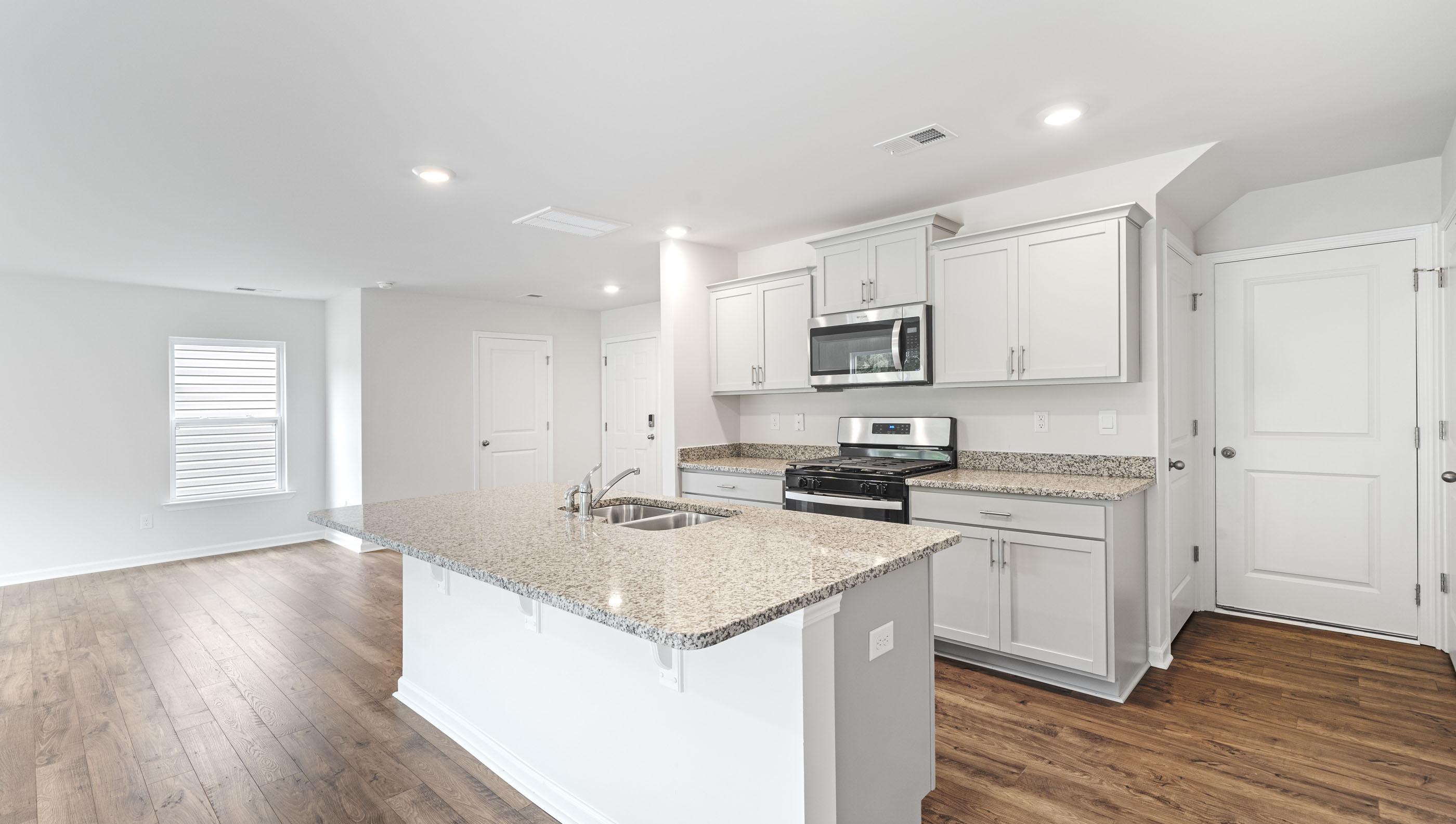Kitchen with island and cabinets.
