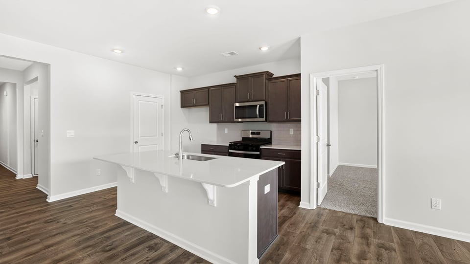 Kitchen with island and cabinets.