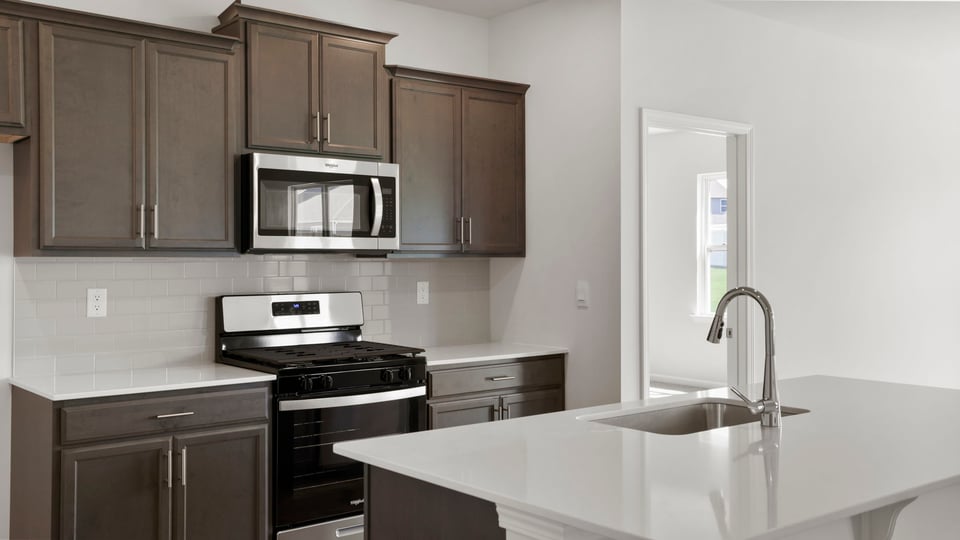 Kitchen with island and cabinets.