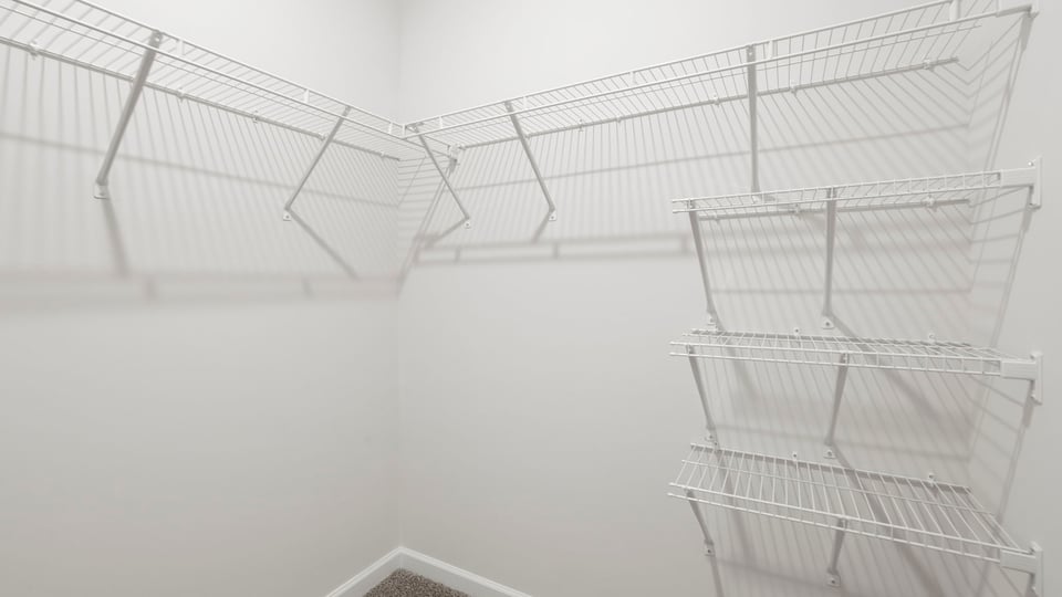 Primary closet with shelf.