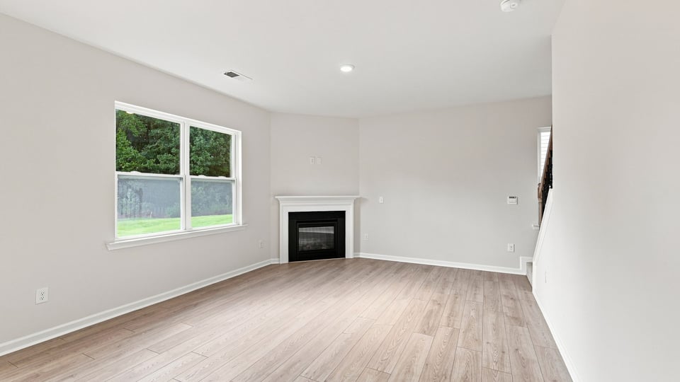 Living room with fireplace and windows.