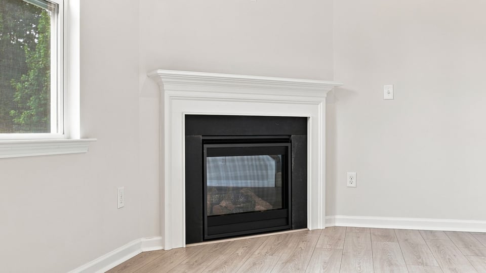 Living room with fireplace and windows.
