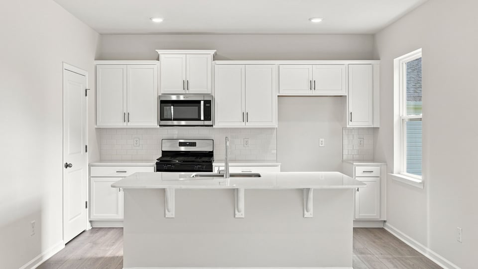 Kitchen with island and cabinets.