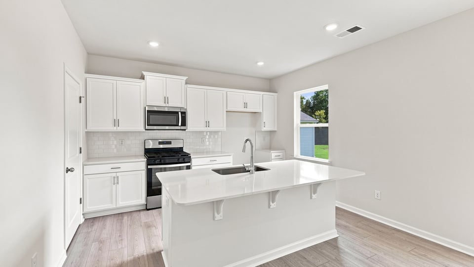 Kitchen with island and cabinets.