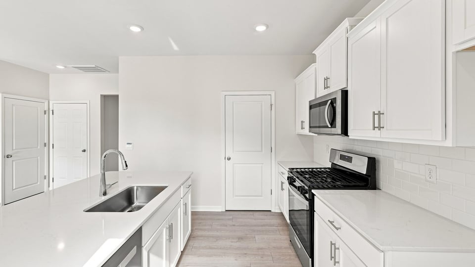 Kitchen with island and cabinets.