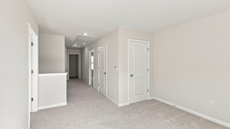 Bedroom with carpet and windows.