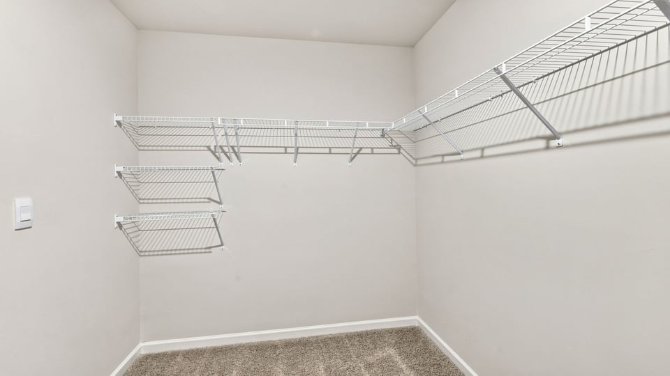 Primary closet with shelf.