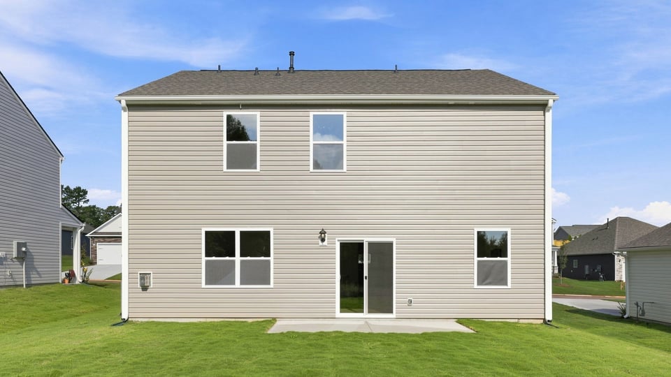 Back exterior with large backyard.