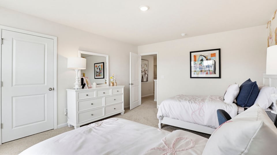 Bedroom with carpet and windows.