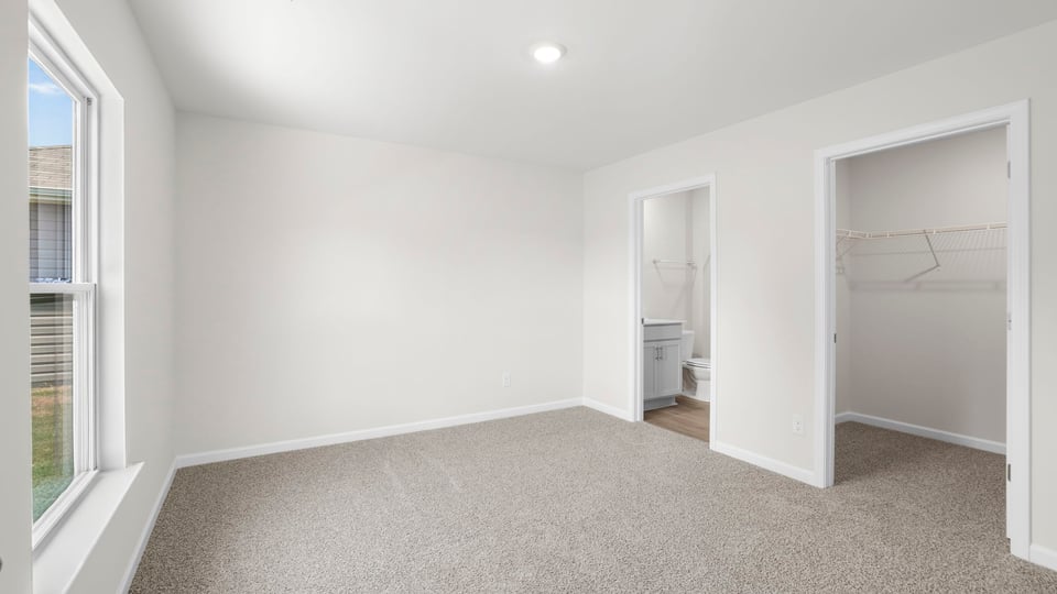 Bedroom with carpet and window.