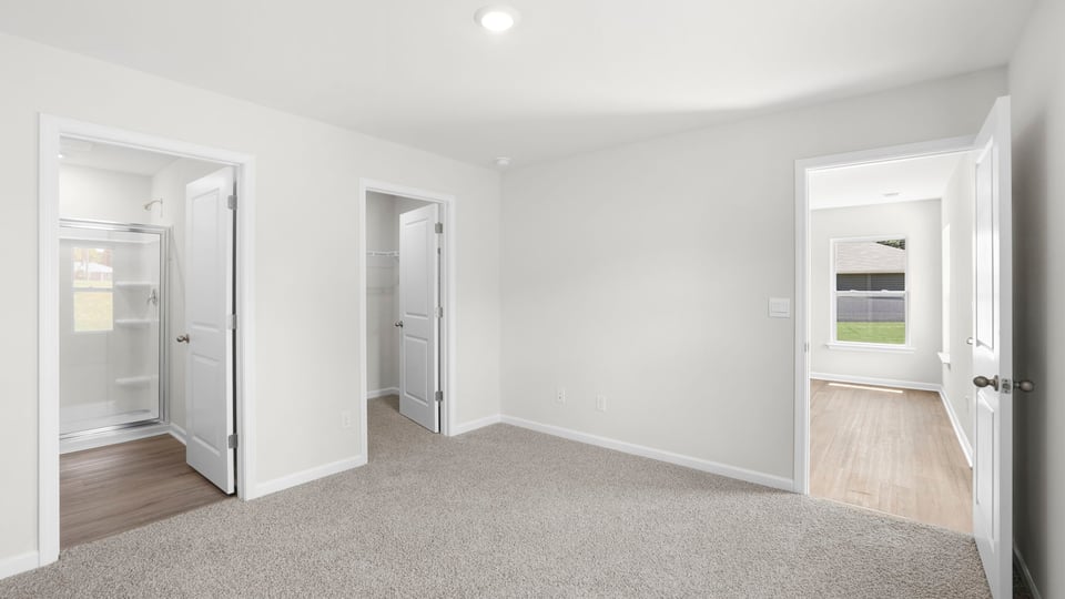 Bedroom with carpet and window.