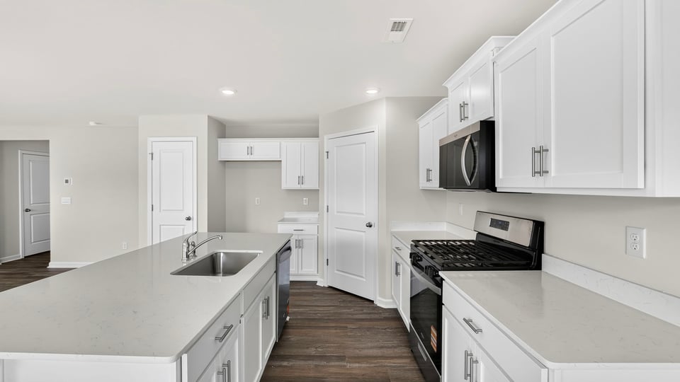 Kitchen and island with quartz countertops.