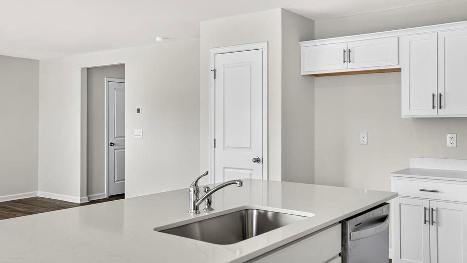 Kitchen and island with quartz countertops.