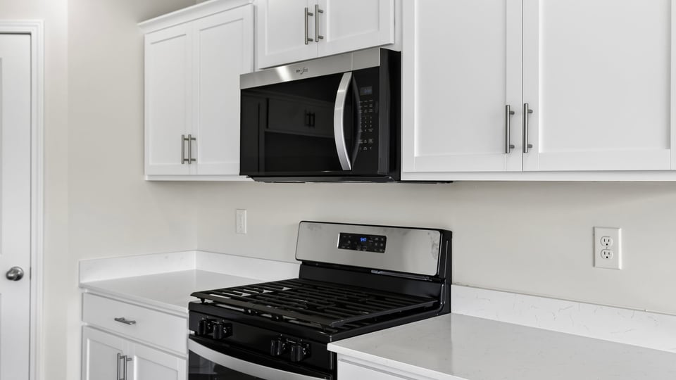 Kitchen and island with quartz countertops.