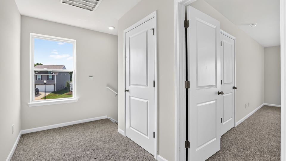 Hallway view of bedrooms.