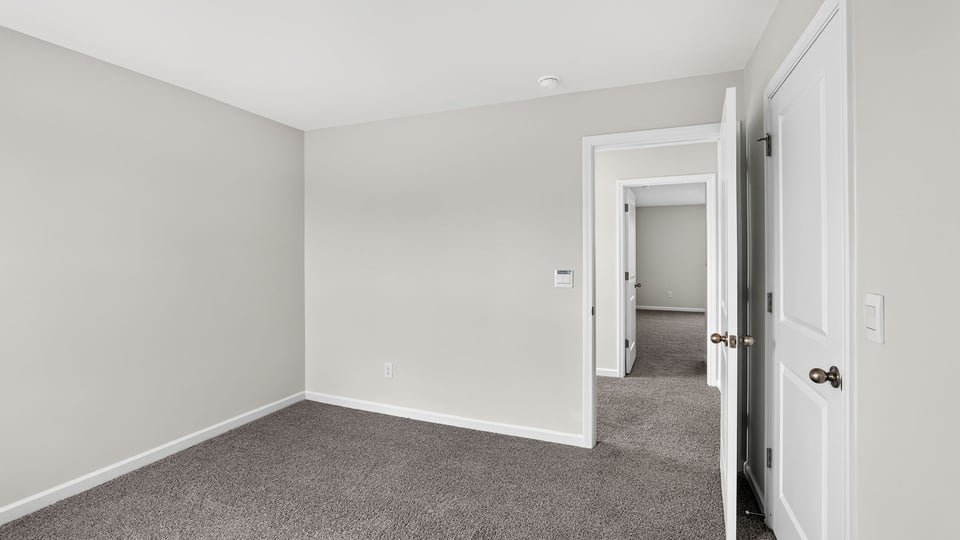 Bedroom with carpet and window.