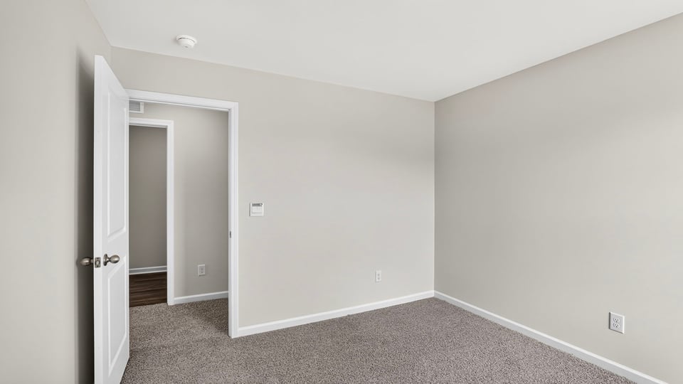 Bedroom with carpet and window.