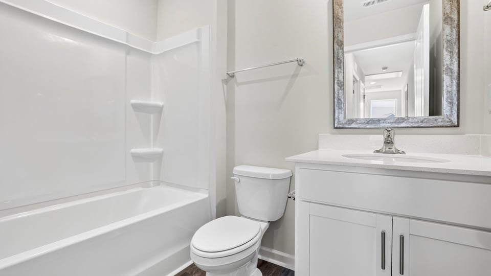 Bathroom with single vanity sink and bathtub.