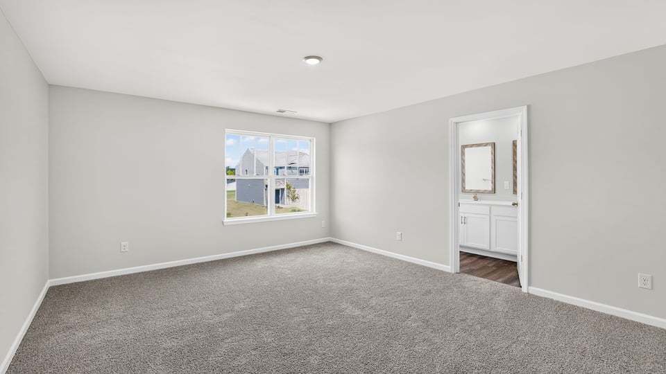 Bedroom with carpet and window.