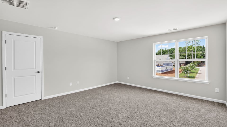 Bedroom with carpet and window.