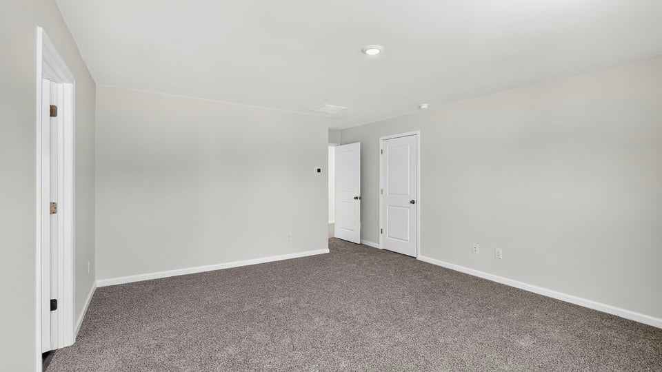 Bedroom with carpet and window.