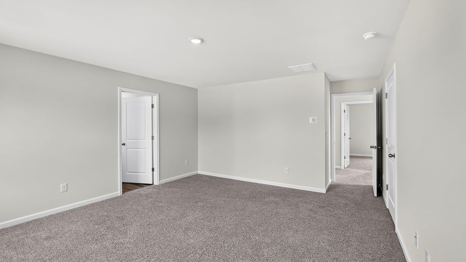 Bedroom with carpet and window.