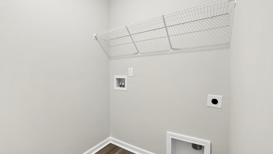 Laundry room with hanging storage racks.