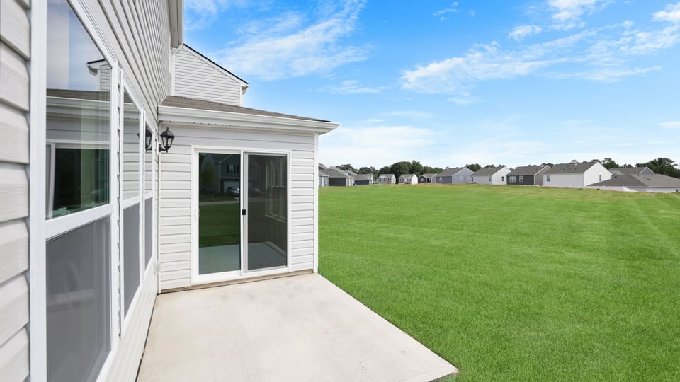 Back exterior of home with patio.