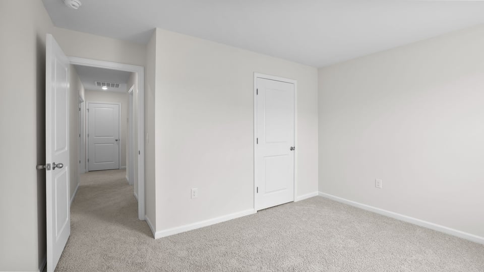 Bedroom with carpet and window.