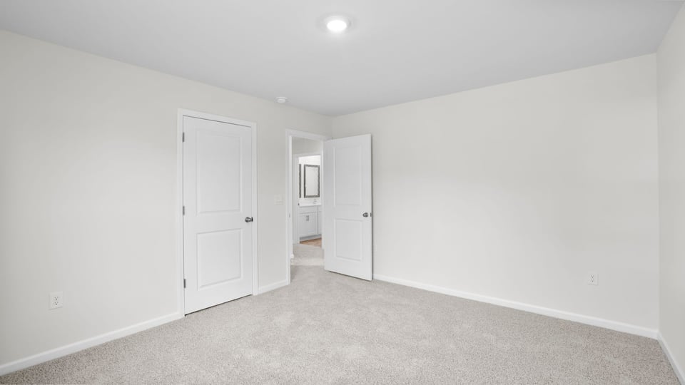 Bedroom with carpet and window.