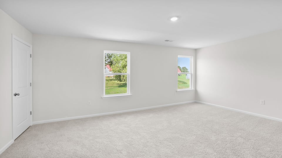 Bedroom with carpet and window.