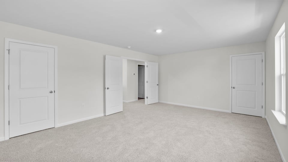 Bedroom with carpet and window.
