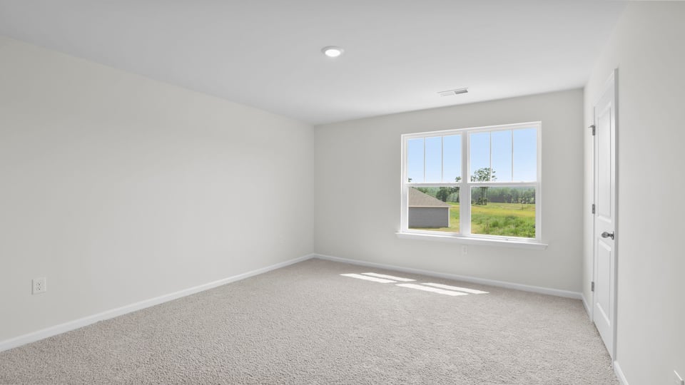 Bedroom with carpet and window.