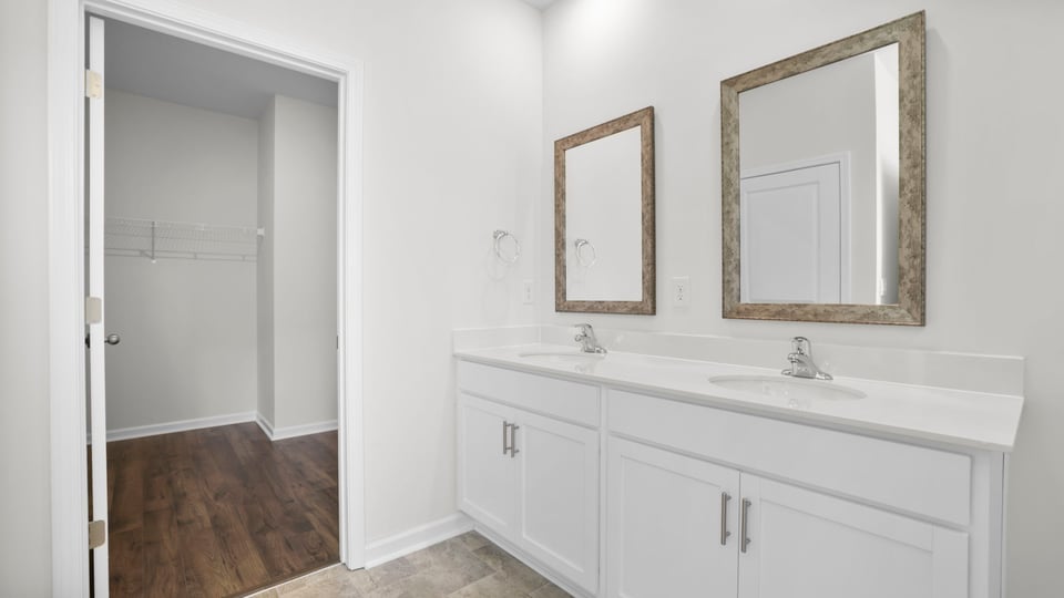 Bedroom with double vanity.