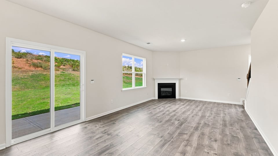 Living room with windows and fireplace.
