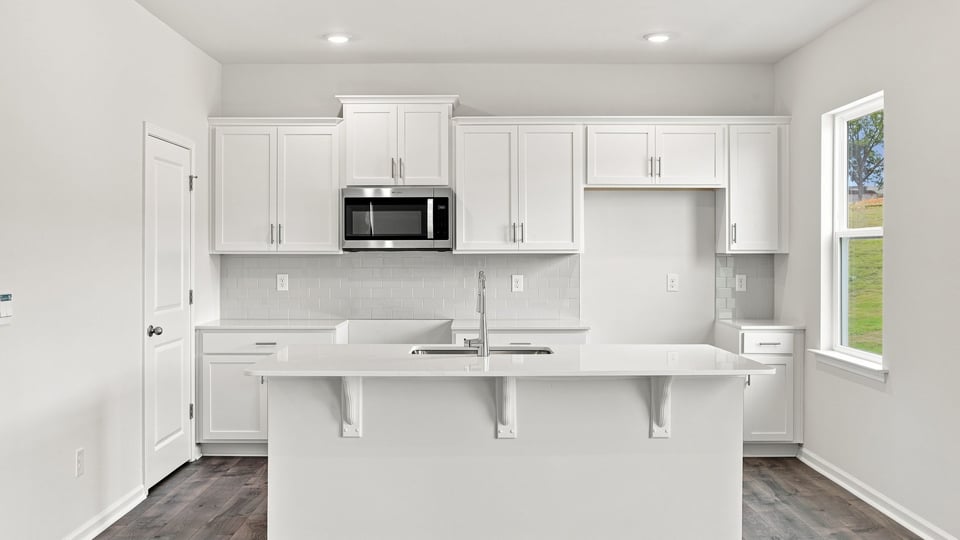 Kitchen and island with quartz countertops.