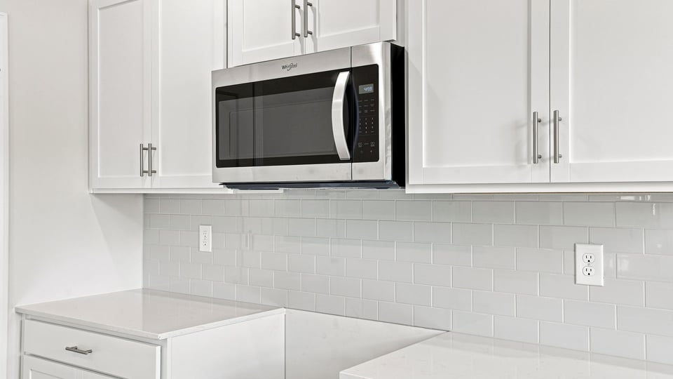 Kitchen and island with quartz countertops.