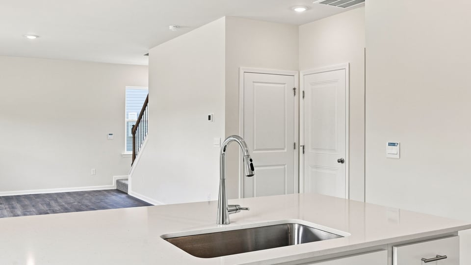 Kitchen and island with quartz countertops.