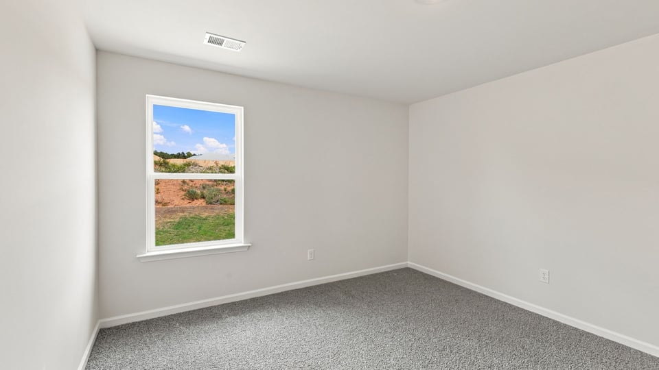 Bedroom with carpet and window.