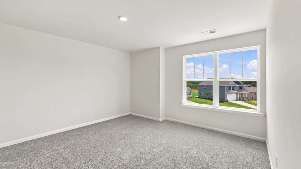 Bedroom with carpet and window.