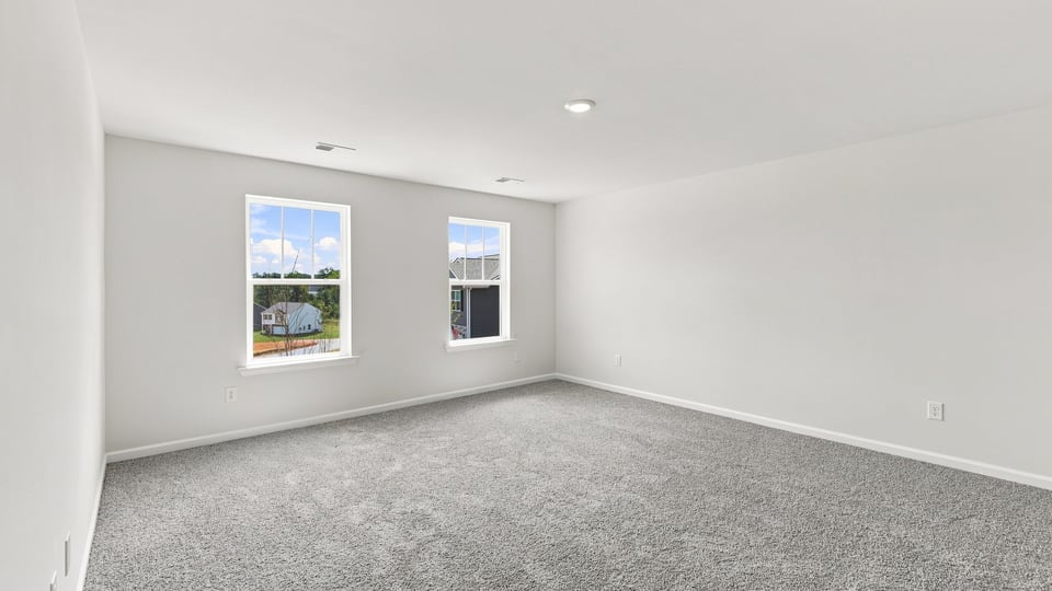 Bedroom with carpet and window.